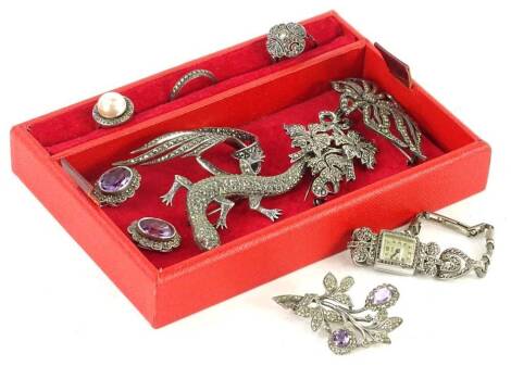 A small quantity of marcasite set jewellery, to include a pair of silver amethyst and marcasite clip on earrings, an amethyst claw spray brooch, silver lizard brooch, three marcasite dress rings, marcasite pocket watch and various other brooches. (a quant