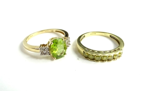 Two 9ct gold dress rings, being a 1/2ct diamond set in 9ct gold, with certificate of authenticity stating the colour to be yellow and limited edition, and a peridot type cz stone dress ring, (2), 4.3g all in.