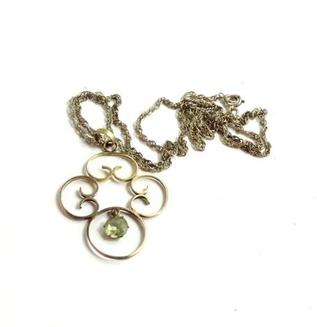 An Art Nouveau style pendant and chain, with single four section ball drop, set with pale green stone, on silver chain, stamped 925, 3.6g all in.