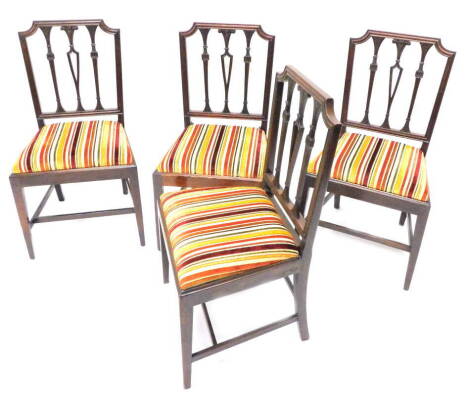 A set of four 19thC mahogany dining chairs, each with a reeded and leaf carved uprights, flanking central splat carved with fleur de leis, drop in seats on square tapering legs.