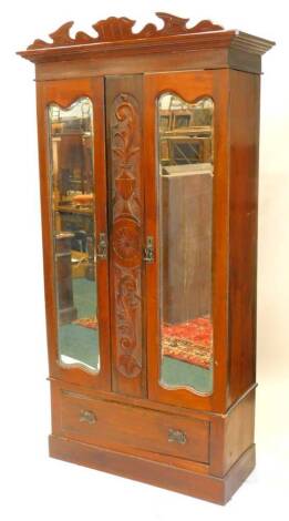 A Victorian walnut wardrobe, with two mirrored doors, above a frieze drawer on plinth, 100cm W.