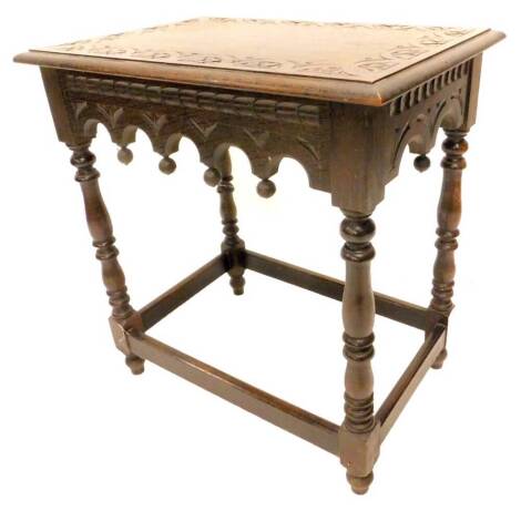 An early 19thC stained oak occasional table, the rectangular top with a carved border on turned supports, 66cm W.