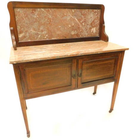 An Edwardian mahogany and chequer banded wash stand, the raised back and top with rouge marble, above two panel doors on square tapering legs with castors, 107cm W.