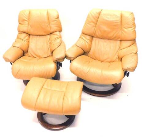 A pair of Stressless tan coloured leather swivel armchairs, and two matching stools.