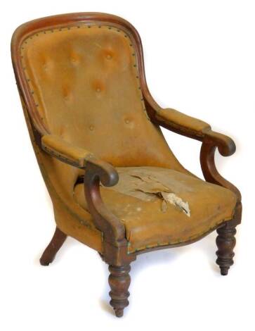 A Victorian mahogany show frame armchair, with a buttoned back, padded arm rest and seat, upholstered in leatherette, on turned tapering legs, with castors. (AF)