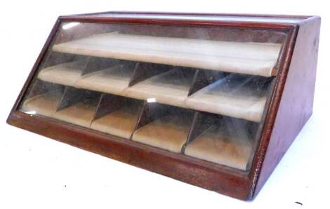 An early 20thC mahogany counter top display unit, of tapering form containing various velvet lined compartments, 81cm W.