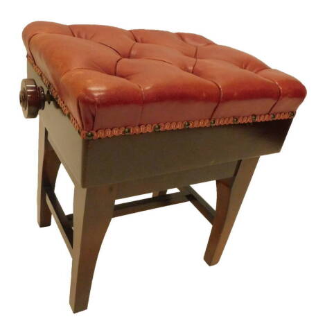 A modern mahogany piano stool, with a red leatherette buttoned seat, and double adjustment, the seat 45cm W. The upholstery in this lot does not comply with the 1988 (Fire & Fire Furnishing) Regulations, unless sold to a known exporter or upholsterer it w