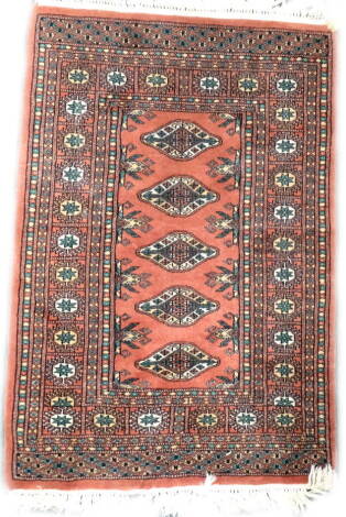 An Afghan rug, with three medallions on a red ground, 115cm x 79cm, a similar runner and a modern Kilim.