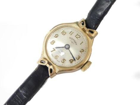 A 9ct gold Rotary ladies wristwatch, with small circular dial, with silvered colour dial, in 9ct gold frame, with bow type decoration to each end, with 17 jewel movement, on thin black leather strap, 10g all in.