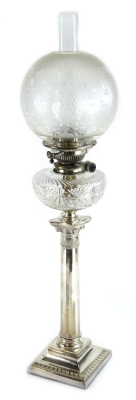 A late 19th/early 20thC silver plated oil lamp, the part frosted shade decorated with Art Nouveau style flowers, etc., the mechanism stamped maker's Duplex patent, above a clear cut glass reservoir on Corinthian faceted column and square base, 77cm H over