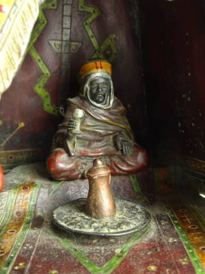 A cold painted bronze and spelter lamp base, modelled in the form of a carpet seller, with coffee pot, seated within an elaborate Arabic tent, in the manner of Franz Bergman, 33cm H. - 2