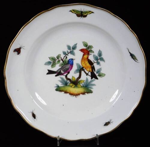 A late 19thC Meissen porcelain plate, of shaped outline with gilt rim, centred with handpainted exotic birds on tree boughs, with outer insect border, blue cross marks beneath, 24cm W.