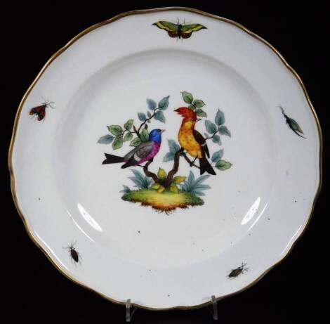 A late 19thC Meissen porcelain plate, of shaped outline with gilt rim, centred with handpainted exotic birds on tree boughs, with outer insect border, blue cross marks beneath, 24cm W.