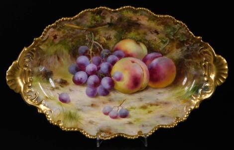 A Royal Worcester porcelain Frank Roberts dish, painted with fruits, grapes and peaches, of ellipse form with gilt highlights, 1918, 32cm W.