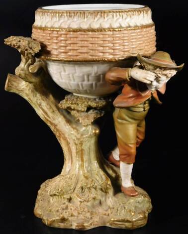 A Royal Worcester porcelain centre piece, with shaped bowl, on a tree bough aside figure, on a rock work base, no. 1315, 1895, printed pink marks beneath, 29cm H.