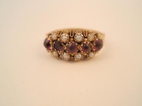 A gypsy style ring set with amethyst and seed pearls