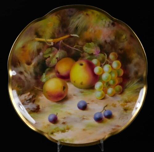 An early 20thC Royal Worcester Frank Roberts plate, handpainted with apples and grapes, with a flared gilt highlighted rim, printed pink marks beneath, 22cm W.