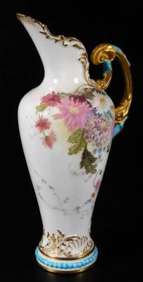 A Royal Worcester ewer, handpainted and raised with flowers, with gilt highlights, shaped handle and bead lined foot, no. 1587, green printed marks beneath, 1900, 24cm H, a Royal Worcester shell no. G716 and a Royal Worcester jug no. 1094. (3) - 2