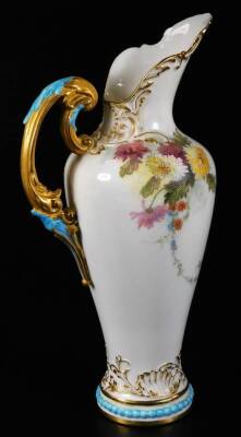 A Royal Worcester ewer, handpainted and raised with flowers, with gilt highlights, shaped handle and bead lined foot, no. 1587, green printed marks beneath, 1900, 24cm H, a Royal Worcester shell no. G716 and a Royal Worcester jug no. 1094. (3) - 3