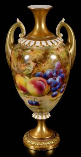 A Royal Worcester Frank Roberts urn vase, the tapering body handpainted with peaches and grapes, with gilt highlights, inverted neck and stem, acanthus capped handles and circular foot, no. H313, pink printed marks beneath, 1917.