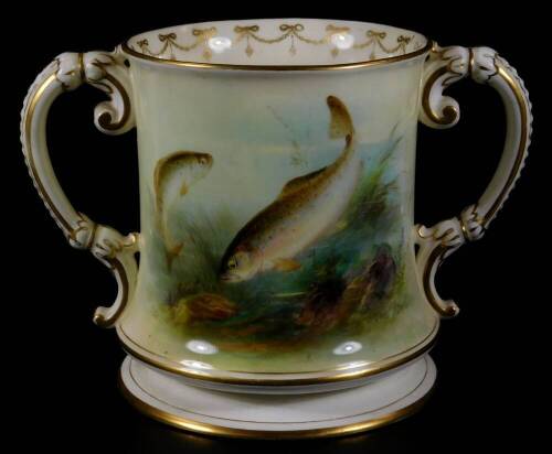 A Royal Worcester porcelain Harry Davis loving cup, the inverted body handpainted with fishes, flanked by gilt highlighted handles with an inner garland banding, on a circular foot, pink printed marks beneath, 1911, 17cm H.