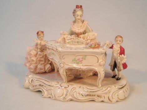 An Irish Dresden porcelain figure group of a crinoline lady and children