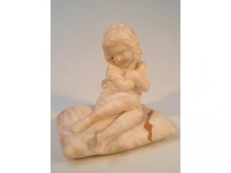 A Victorian carved marble figure of a seated young girl on a cushion