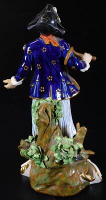 A late 18thC Derby Porcelain figure, of a sailor in gilt highlighted finery and blue striped pantaloons, on a naturalistic bocage base, with gilt scroll highlights, collector's label beneath, impressed no. 316, 23cm H - 2