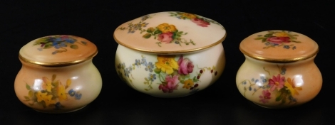 A Royal Worcester blush ivory pair of trinket boxes and covers, shape code 2133, puce factory mark, c1904, 4cm Dia. together with a larger example, c1900, 6.5cm Dia. (3)