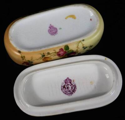 A Royal Worcester blush ivory hair grip box and cover, puce factor mark, c1913, 10cm L, together with a blush ivory miniature cup and saucer, green factory mark, saucer 8cm Dia. (2) - 4