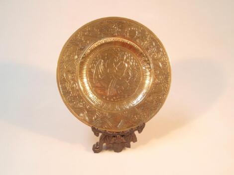 A heavy Chinese brass dish decorated with dragons