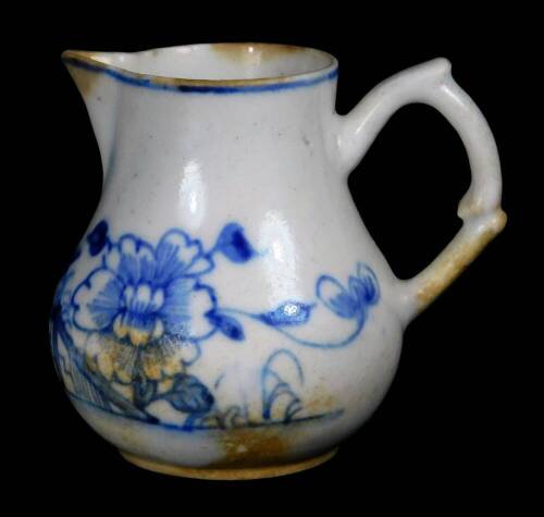 A early Bow Porcelain sparrow jug, c1756, with crabstock handle painted in vivid blue with the Prunus Fence pattern, 7cm H.