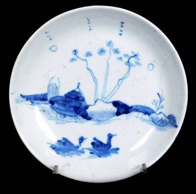 A very rare and early Worcester porcelain saucer, 1752/53, painted in the Swimming Duck pattern, scratch cross period period but unmarked, 13cm Dia. (AF) See Worcester Blue & White Porcelain by Branyan, French and Sandon page 144, rare pattern.