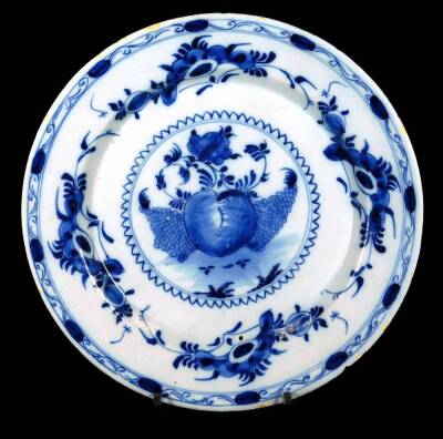 An 18thC Dutch Delft pottery plate, decorated with fruit and flowers, 26cm Dia.