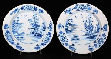 An English Delft pottery side plate, c1750, decorated in blue and white oriental landscapes with a floral border, unmarked, 17cm Dia. (2)