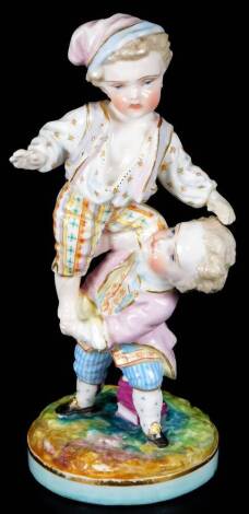 A Marcolini Meissen porcelain group, performing acrobatics in 18thC dress, underglaze blue cross sword mark, 17cm H.