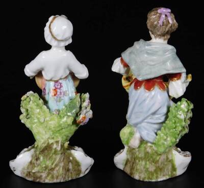 A pair of mid 19thC continental porcelain salt seller figures, of girls holding apron or basket, marked A/R, 12cm H. - 3