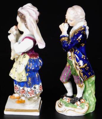 A 19thC Derby porcelain figure of a girl holding a sheep, in red, marked 23, 12cm H, together with a Derby model of a gallant playing a pipe, incised no.10 and 33, gilder no.60 12cm H. (2) - 2