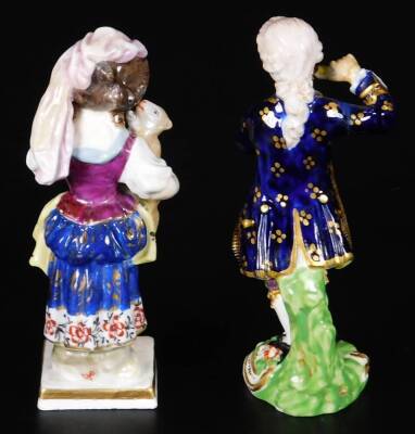 A 19thC Derby porcelain figure of a girl holding a sheep, in red, marked 23, 12cm H, together with a Derby model of a gallant playing a pipe, incised no.10 and 33, gilder no.60 12cm H. (2) - 3