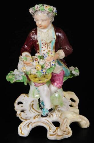 A Derby porcelain figure of a gallant, c1775, holding a basket of flowers, on a rococo base, incised 190 size 2, 12cm H. (AF)