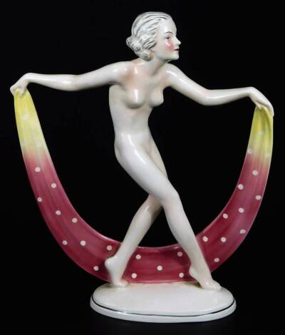 A continental Art Deco figure of a nude female, holding a spotted cloth on oval foot, marked HA beneath, 30cm H.