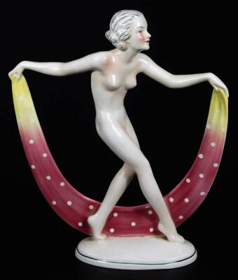 A continental Art Deco figure of a nude female, holding a spotted cloth on oval foot, marked HA beneath, 30cm H.