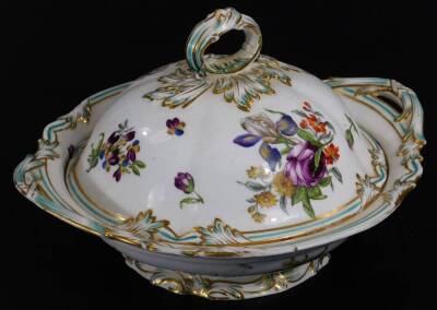 A 19thC continental porcelain part dinner service, each piece profusely decorated with handpainted flowers predominately in blue, green and orange, to include two lidded tureens, 30cm W, a pair of sauce dishes and covers, serving dishes, plates, etc. each - 9