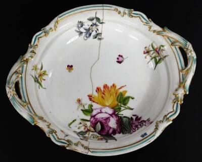 A 19thC continental porcelain part dinner service, each piece profusely decorated with handpainted flowers predominately in blue, green and orange, to include two lidded tureens, 30cm W, a pair of sauce dishes and covers, serving dishes, plates, etc. each - 14