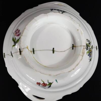 A 19thC continental porcelain part dinner service, each piece profusely decorated with handpainted flowers predominately in blue, green and orange, to include two lidded tureens, 30cm W, a pair of sauce dishes and covers, serving dishes, plates, etc. each - 15