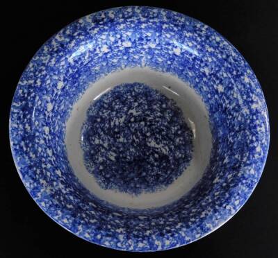 A 19thC blue and white sponge ware bowl, of circular form, 33cm Dia. and continental tin glazed charger, heavily decorated with a repeat geometric pattern predominately in blue, yellow and turquoise, on a circular foot. (2) - 6