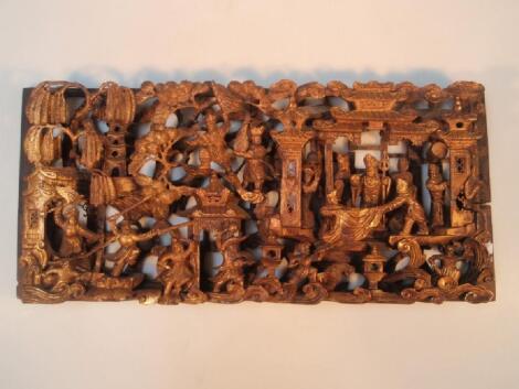 A Chinese pierced gilt relief carved wall panel profusely decorated with