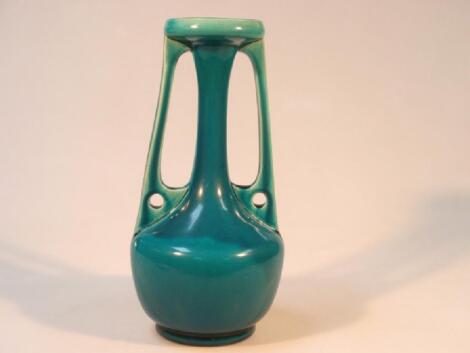 A Bretby blue glazed stylised Art Nouveau pottery vase with two pierced elongated handles