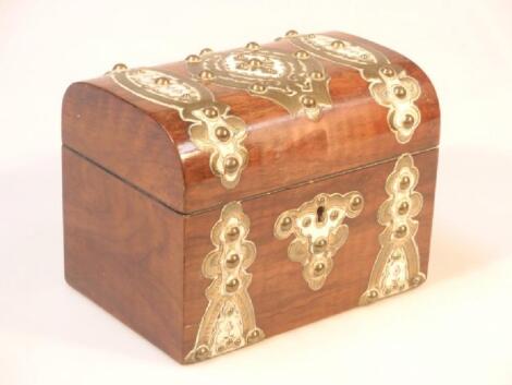 A Victorian walnut tea caddy decorated with studded brass strapwork and ivory