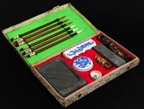 A Chinese blue and white porcelain scribe set, in material box, 31cm W, with slate lidded jar, seal, scribe implements, etc.